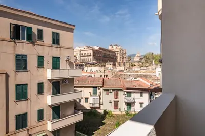 a courtyard with potted plants in front of a building at GuestHost - Ballarò Flat dei Sovrani x6 in Palermo