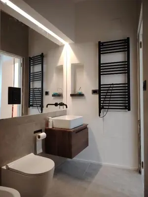 a bathroom with a white toilet and a sink at Cappuccetto Rosso Sweet Apartment Palermo in Palermo