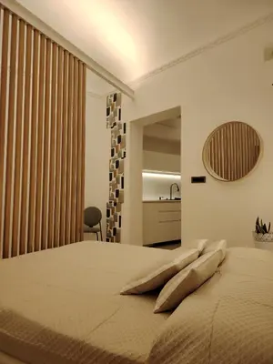 a bedroom with a large bed with a large window at Cappuccetto Rosso Sweet Apartment Palermo in Palermo