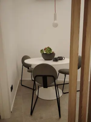 a table and chairs with a potted plant on it at Cappuccetto Rosso Sweet Apartment Palermo in Palermo