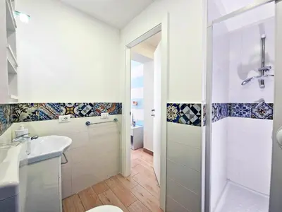 a bathroom with a shower and a toilet and a sink at Casa Mo' in Isola delle Femmine