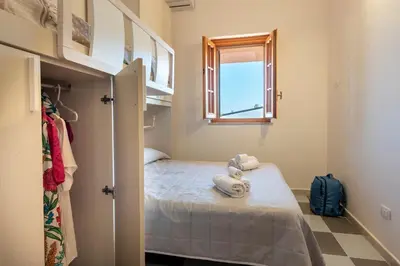 a small room with a bed and a window at Clizia Holiday in Campofelice di Roccella