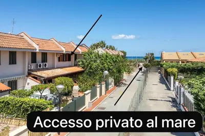 a street with houses and a sign that reads accessospora pyrida all at Clizia Holiday in Campofelice di Roccella