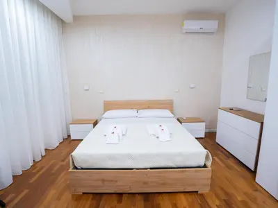 a bedroom with a bed with white sheets at Amuri Luxury Palermo centro in Palermo
