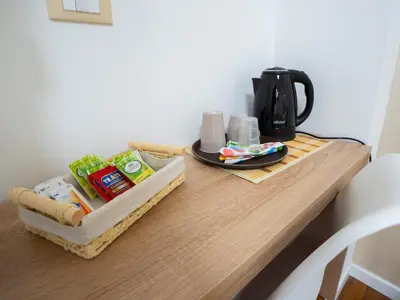 a table with a coffee pot and a plate of food at Amuri Luxury Palermo centro in Palermo