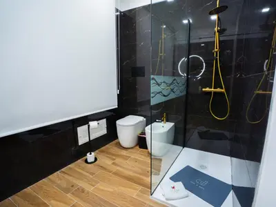 a bathroom with a glass shower and a toilet at Amuri Luxury Palermo centro in Palermo