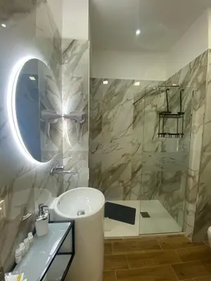 a bathroom with a sink and a shower at Amuri Luxury Palermo centro in Palermo