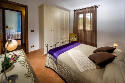 a bedroom with a large bed and a window at Villa del Carrubo in Castellammare del Golfo in Castellammare del Golfo