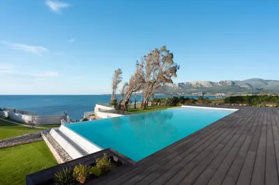 a swimming pool with the ocean in the background at Ammare Luxury Villa by Le Dhome Sicily in Trappeto