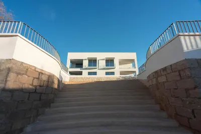 a set of stairs leading up to a building at Ammare Luxury Villa by Le Dhome Sicily in Trappeto