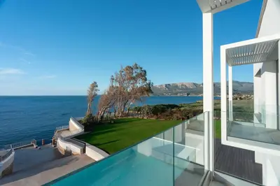 a view of the ocean from the balcony of a house at Ammare Luxury Villa by Le Dhome Sicily in Trappeto