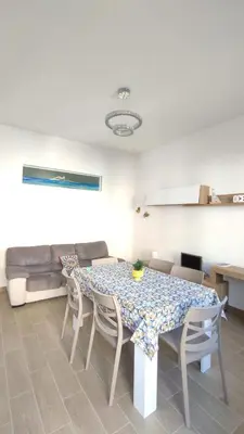 a dining room with a table and chairs at Isola delle Femmine vacation home in Isola delle Femmine
