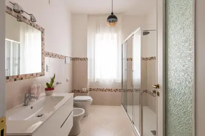 a bedroom with a bed and a mirror at Vittorio Veneto Apartment by Wonderful Italy in Palermo