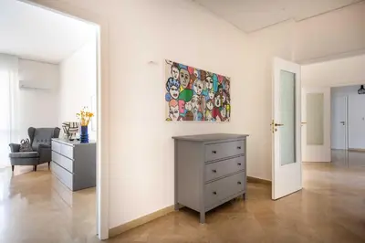 a bedroom with a white bed and a green wall at Vittorio Veneto Apartment by Wonderful Italy in Palermo