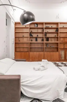 a bedroom with a large bed and a black lamp at Large two-room apartment within walking distance of the Teatro Massimo in Palermo