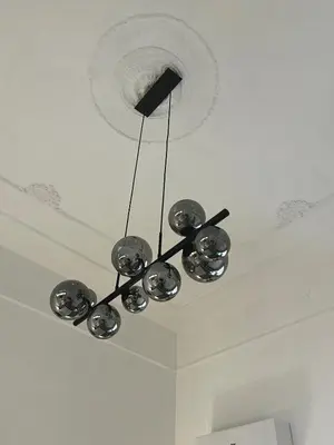 a chandelier hanging from a ceiling in a room at Large two-room apartment within walking distance of the Teatro Massimo in Palermo