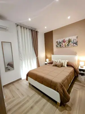 a bedroom with a large bed and a large window at La casa di Zucchero in Monreale