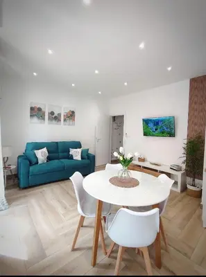 a living room with a table and a blue couch at La casa di Zucchero in Monreale