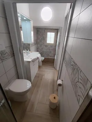 a bathroom with a toilet and a sink and a mirror at La casa di Zucchero in Monreale