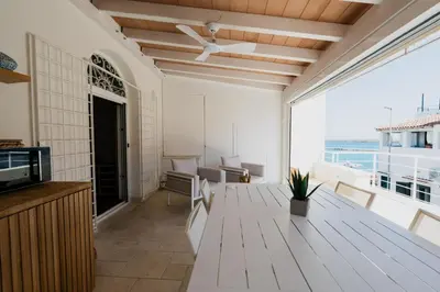 a living room with a table and a view of the ocean at Sea House - Suite vista mare in Terrasini