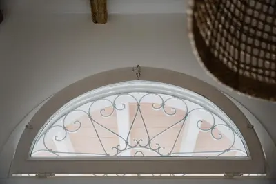 an arched window in a white room with at Sea House - Suite vista mare in Terrasini