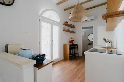 a white kitchen with a sink and a counter at Sea House - Suite vista mare in Terrasini