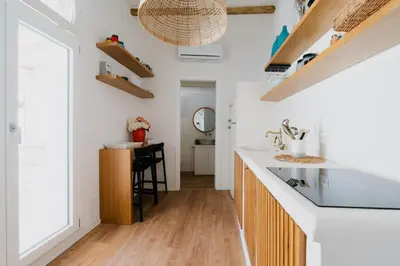 a kitchen with white walls and a counter and a sink at Sea House - Suite vista mare in Terrasini