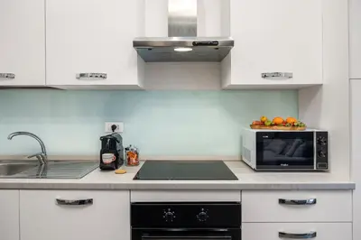 a kitchen with a sink and a microwave at Casta Diva Fervore Apartments Self Check-in in Palermo