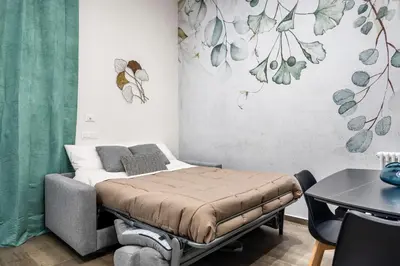 a bedroom with a bed and a table with at Casta Diva Fervore Apartments Self Check-in in Palermo