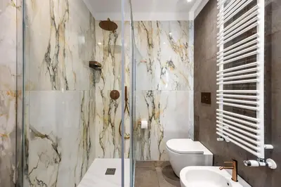 a bathroom with a toilet and a glass shower at Casta Diva Fervore Apartments Self Check-in in Palermo