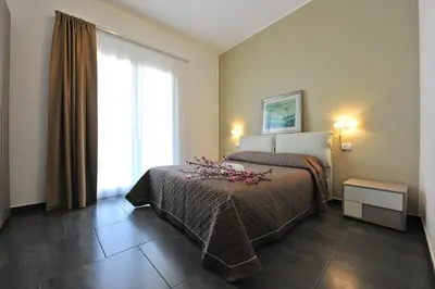 a hotel room with a bed and a window at Case Mistretta in Altavilla Milicia