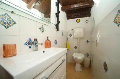 a bathroom with a sink and a toilet at Ballarua in Palermo
