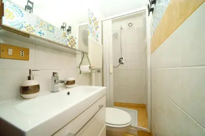 a bathroom with a sink and a toilet and a shower at Ballarua in Palermo
