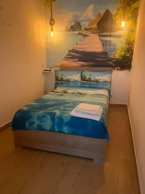 a bed in a room with a painting of a pier at Casa mattya in Palermo