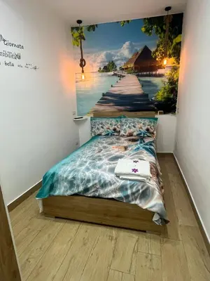 a bedroom with a painting of a pier at Casa mattya in Palermo