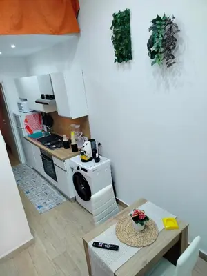 a small kitchen with a table and a microwave at Casa mattya in Palermo