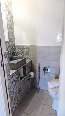 a bathroom with a sink and a toilet at La Casetta in Piazza in Palermo
