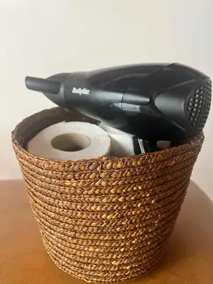a hair dryer in a basket on a table at Casa Teré in Palermo