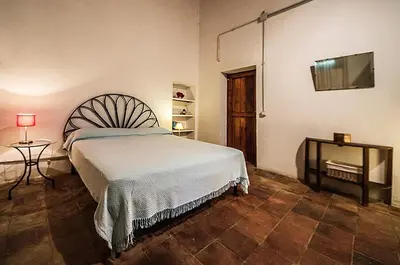 a bedroom with a bed and a flat screen tv at Casa Portico, con piscina in comune in Terrasini