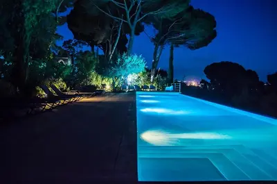 a swimming pool lit up at night at Casa Portico, con piscina in comune in Terrasini