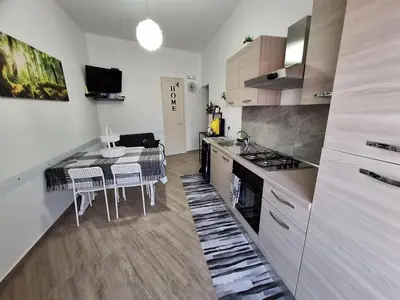 a kitchen with a table with chairs and a stove at Tra I Normanni E Cattedrale Apartament Palermo in Palermo