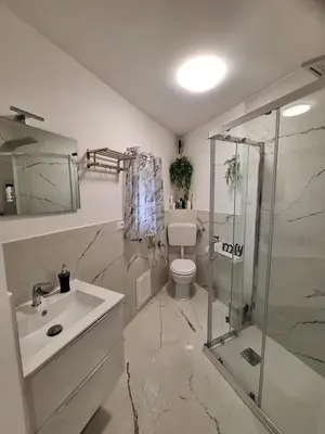 a bathroom with a toilet and a sink and a shower at Tra I Normanni E Cattedrale Apartament Palermo in Palermo
