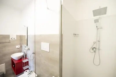 a bathroom with a shower with a toilet and a sink at Villa Amelia in Castellammare del Golfo
