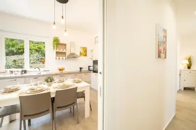 a kitchen with a table and chairs in a kitchen at Villa Amelia in Castellammare del Golfo