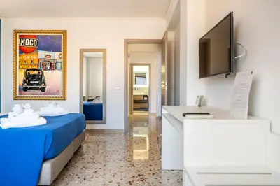 a hotel room with a bed and a desk at Centoquaranta Apartment in Terrasini
