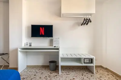 a dining room table with plates and wine glasses at Centoquaranta Apartment in Terrasini