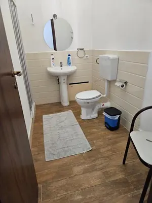a bathroom with a toilet and a sink at Al Maqueda in Palermo