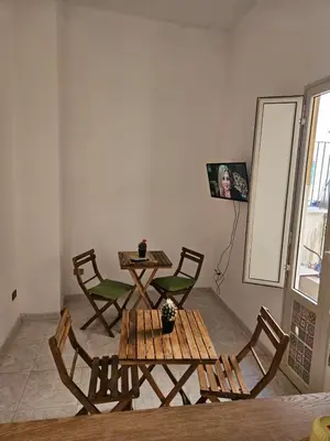 a room with a table and chairs and a table and a table and chairs at Al Maqueda in Palermo