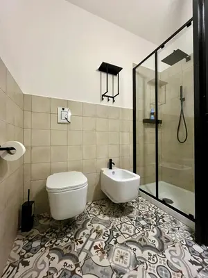 a bathroom with a toilet and a sink and a shower at Villa Mediterranea in Carini