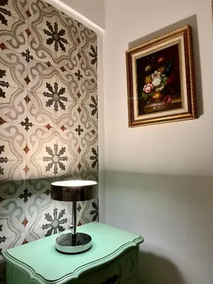 a lamp on a table in a room with a painting at Villa Mediterranea in Carini